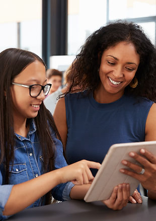 A mentor and student learning together on a tablet